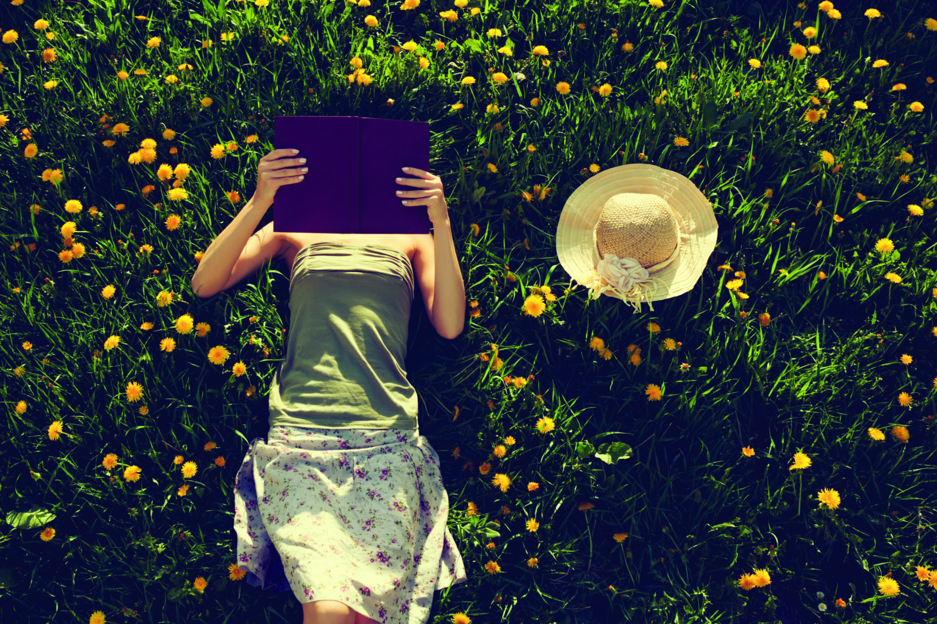 Girl reading book in grass