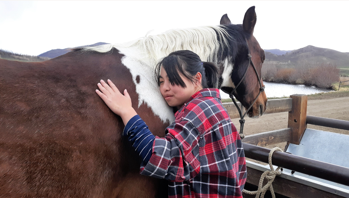 rider hugging horse at retreat